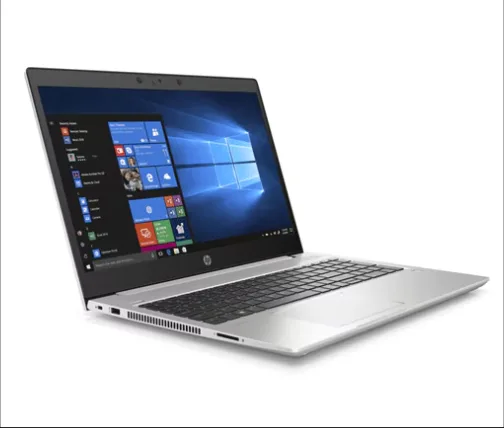 Slim dark HP laptop closed beside notebooks on a warm wood counter